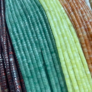 May include: Multiple strands of small, cylindrical stone beads arranged in a parallel vertical pattern. The colours include dark brown, deep teal green, light lime green, and a warm orange, each featuring a smooth, polished finish.