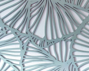 May include: A light blue wall decor with a geometric pattern of overlapping circles and lines. The design resembles a stylized fan or palm leaf.
