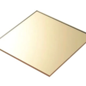 Può includere: Un pezzo quadrato di vetro a specchio color oro.