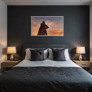 May include: A bedroom with a dark gray wall and a bed with a white and gray duvet. There is a framed picture above the bed with a silhouette of a person standing in front of a sunset with airplanes flying overhead. There are two bedside tables with lamps on them.