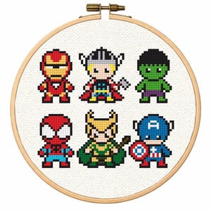 May include: A cross-stitch embroidery hoop featuring six pixelated superhero characters: Iron Man, Thor, Hulk, Spider-Man, Loki, and Captain America. The characters are in vibrant colors, set against a white fabric background.