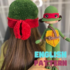 May include: Crochet pattern for a Teenage Mutant Ninja Turtles doll. The doll is green with a red mask and a yellow shell. The pattern is written in English.