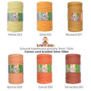 May include: A selection of cotton cord spools in yellow, gold, mustard, apricot, carrot, and terracotta. Each spool is labelled with a colour name and number, and wrapped with a branded paper band.