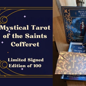 May include: A navy blue box with gold accents contains a tarot deck, a guidebook, and other accessories. The box is labeled "Mystical Tarot of the Saints Cofferet, Limited Signed Edition of 100".