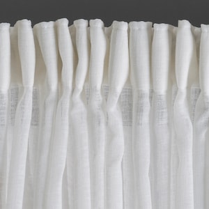 May include: White sheer curtains with a gathered top, creating a ruffled effect. The curtains are made of a lightweight fabric with a subtle texture.