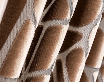 May include: Close-up of a brown and beige fabric with a geometric pattern. The fabric has a soft, velvety texture.