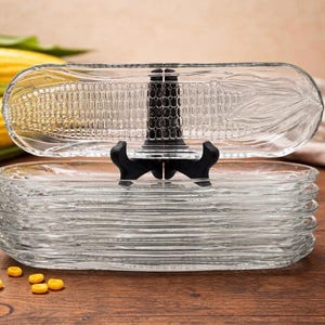 May include: A white ceramic mug with a black handle and the text "But First, Coffee" in a bold, black font. The mug is set against a neutral background, highlighting its simple design.