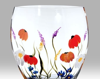May include: A clear glass vase with a hand-painted floral design. The vase features a variety of flowers in shades of red, orange, purple, blue, and white.