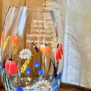 May include: A clear glass vase with a floral design painted on it. The vase has a quote inscribed on it that reads: "Retirement is not the end. It's the start of something wonderful. From your colleagues at HMRO."