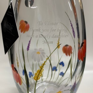 May include: A clear glass vase with a floral design. The vase has a personalized message that reads "To Elinor Thank you for being such a lovely daughter. Mum".