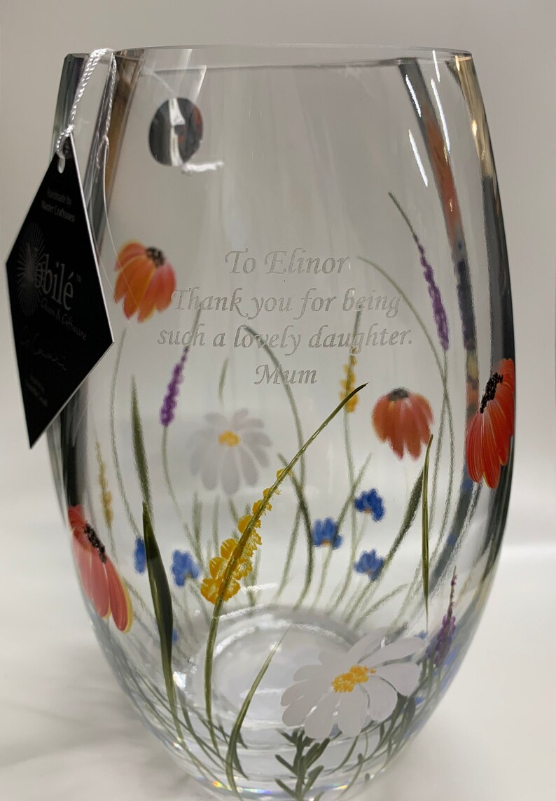 May include: A clear glass vase with a floral design. The vase has a personalized message that reads "To Elinor Thank you for being such a lovely daughter. Mum".
