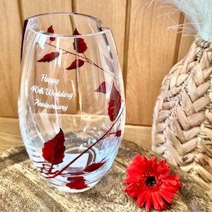May include: A clear glass vase with a red leaf design and the inscription "Happy 40th Wedding Anniversary".