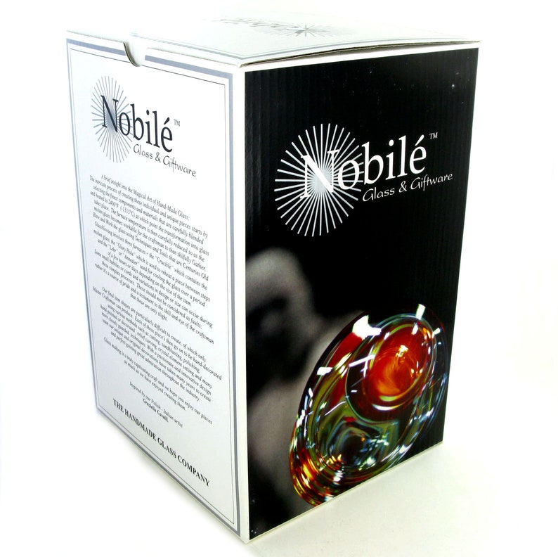 May include: A white box with black text and a photo of a glass goblet. The text on the box reads "Nobil&eacute; Glass & Giftware". The box is for a handmade glass goblet.