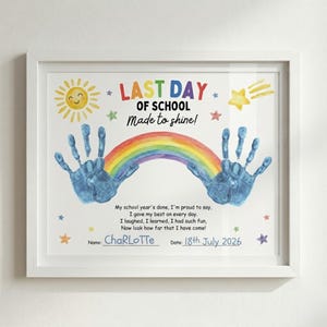May include: White framed print with the text "LAST DAY OF SCHOOL Made to shine!" featuring a rainbow, sun, and handprints. The print includes the name "Charlotte" and the date "18th July 2026".