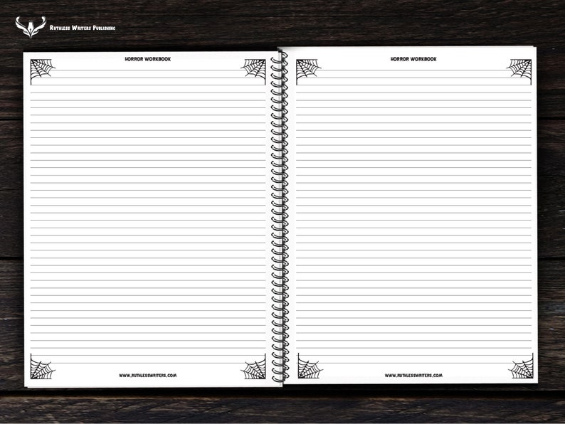 May include: A blank, lined notebook with a black and white spiderweb design on the cover. The notebook has a spiral binding and the text "HORROR WORKBOOK" at the top of the page.