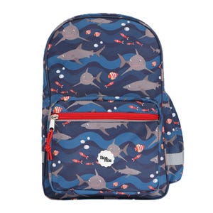 May include: A navy blue backpack with a shark and fish pattern. The backpack features a red zip, a front pocket, and the text "Roamie". The design includes grey sharks, red and orange fish, and white bubbles.