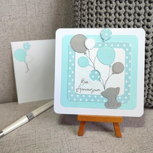 Carte Anniversaire. Bebe et enfant. Garcon. Tons pastels, bleu clair et gris. Éléphant et ballons. Carte cute, tendre et unique. Fait main.