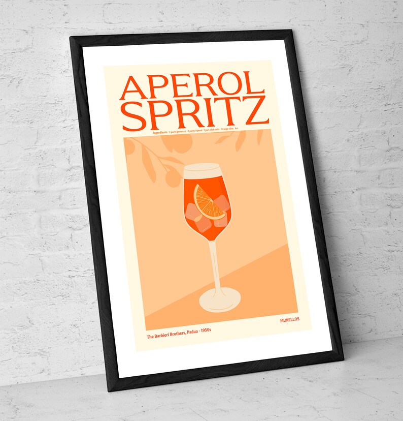 May include: A vintage-style poster featuring an illustration of an Aperol Spritz cocktail in a tall glass with an orange slice and ice cubes. The poster is on a peach background with a stylised orange tree branch in the background. The text "APEROL SPRITZ" is in bold, black letters at the top of the poster. The text "The Barbieri Brothers, Padua, 1950s" is at the bottom of the poster.