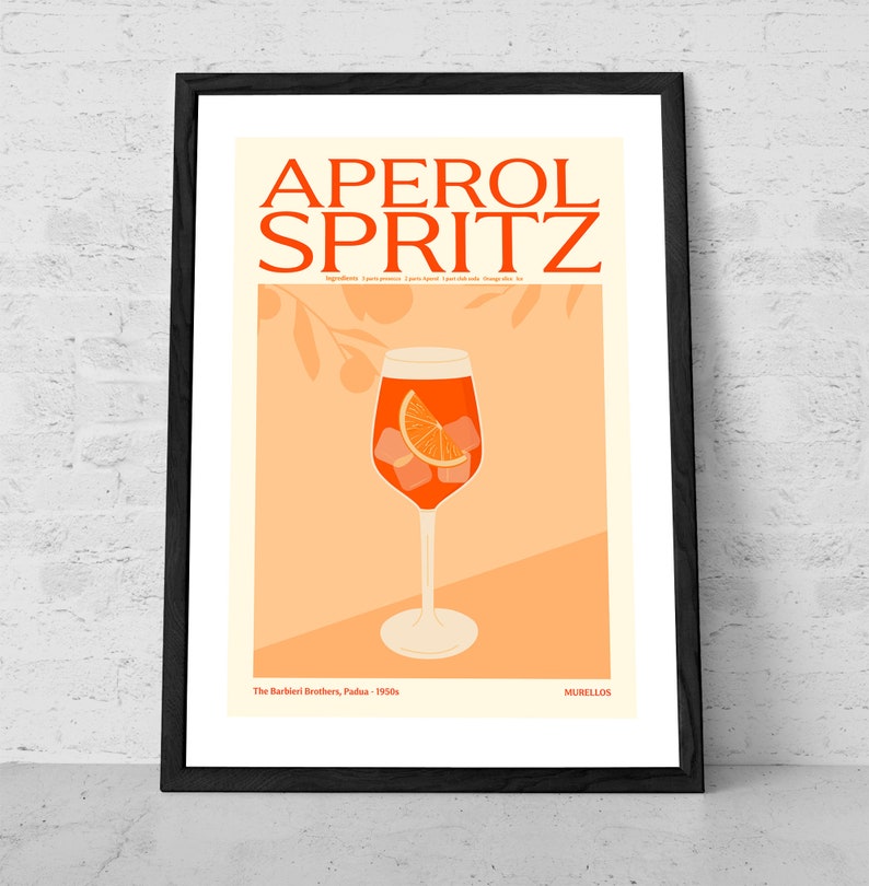 May include: A vintage-style poster featuring an illustration of an Aperol Spritz cocktail in a tall glass with an orange slice and ice cubes. The poster is on a peach background with a black frame and the text "APEROL SPRITZ" in bold, orange letters. The text "The Barbieri Brothers, Padua - 1950s" and "MURILLOS" are also included.