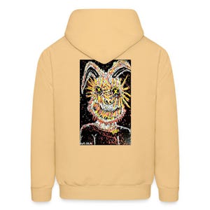 May include: A yellow hoodie with a black and white graphic print of a cartoon creature with yellow eyes and a red mouth. The graphic is on the back of the hoodie. The text "Toxic" is on the creature's neck.