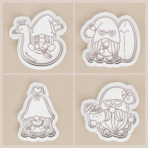 May include: Four white plastic cookie cutters in the shape of gnomes. One gnome is on a swan float, another is holding a surfboard, a third has a bow, and the last is holding a drink with an umbrella. The gnomes are wearing hats and sunglasses.