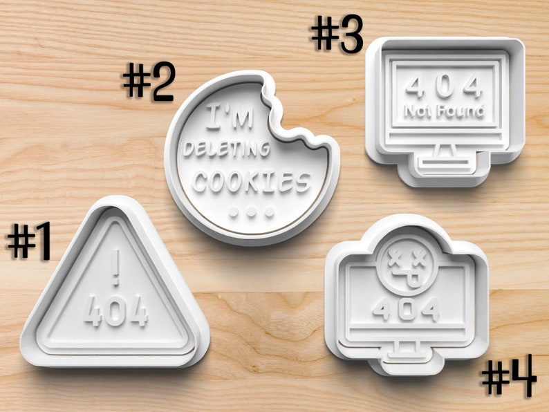 May include: Four white plastic cookie cutters shaped like computer screens and a cookie. The cookie cutter with the cookie has the text "I'M DELETING COOKIES". The other cookie cutters have the text "404" and "Not Found".