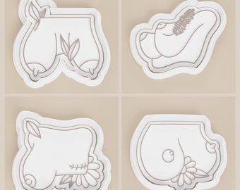 May include: Four white cookie cutters with a light brown outline. The cutters are in the shape of stylized body parts, including breasts and buttocks, with floral and leaf accents. The background is a solid light beige.