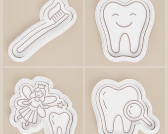 May include: Four white dental-themed cookie cutters. One cutter is a toothbrush with toothpaste, another is a smiling tooth, a third is a tooth fairy with a tooth, and the last is a tooth with a magnifying glass.