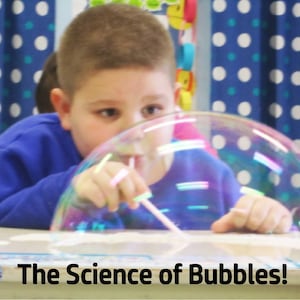 May include: A young person blows a large, iridescent bubble with a straw. The bubble is in front of a blue and white polka dot curtain. The text "The Science of Bubbles!" is at the bottom of the image.