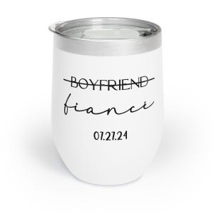 May include: White stainless steel wine tumbler with black text that reads "Boyfriend" with a line through it and "fianc&eacute;" written in cursive. The date "07.21.24" is printed below the text.