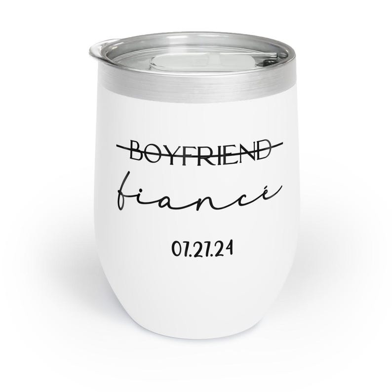 May include: White stainless steel wine tumbler with black text that reads "Boyfriend" with a line through it and "fianc&eacute;" written in cursive. The date "07.21.24" is printed below the text.