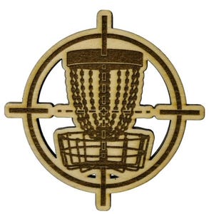 May include: A wooden disc golf target with a brown disc golf basket in the center. The target is in the shape of a bullseye with a crosshair in the center.