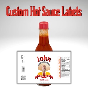 May include: A white label for a hot sauce bottle with a red and yellow birthday theme. The label features a photo of a man wearing a sombrero and a yellow shirt with the text "John Happy Birthday" and "Hot Sauce 10 FL. OZ. - 296 ML".