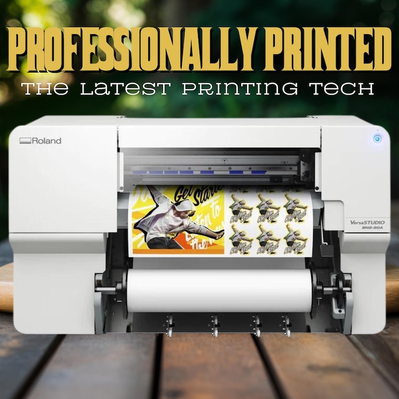 May include: A white Roland VersaStudio BN-20A printer with a roll of white paper and a sheet of printed paper featuring a colourful graphic of a person skateboarding. The printed paper is labelled "Get Started to Rock the World".