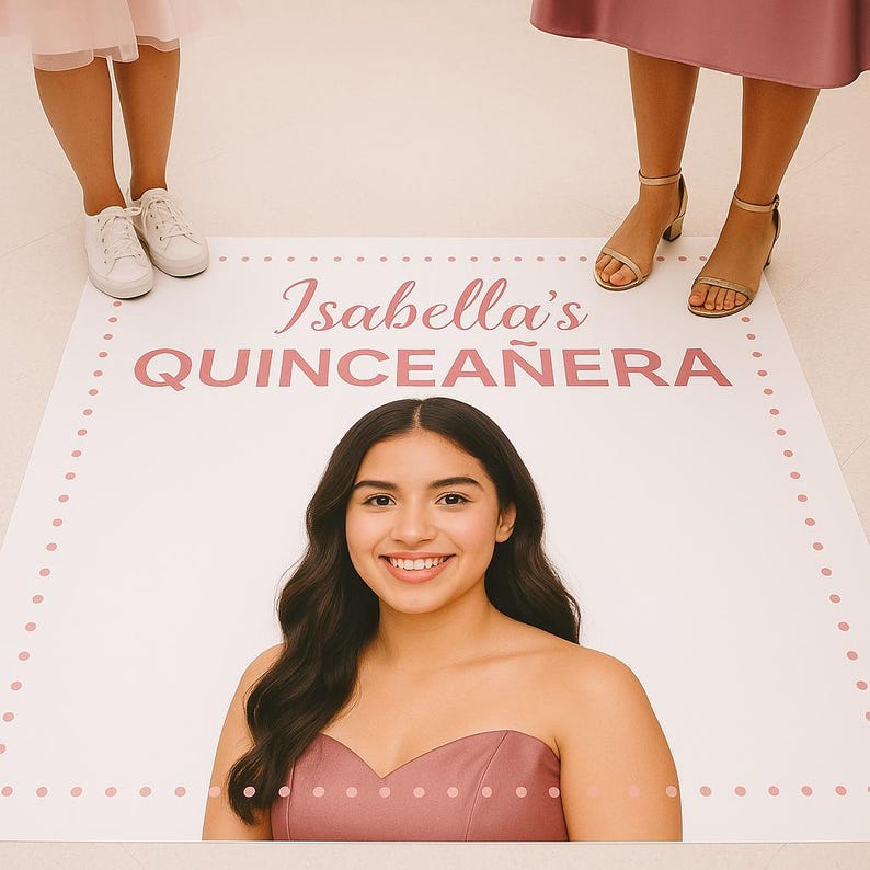 Op de afbeelding: Een grote witte vloermat met de tekst "Isabella's QUINCEA&Ntilde;ERA" in roze. Een jonge vrouw in een roze jurk lacht naar de camera. De mat heeft een gestippelde roze rand. Twee mensen staan bij de mat.
