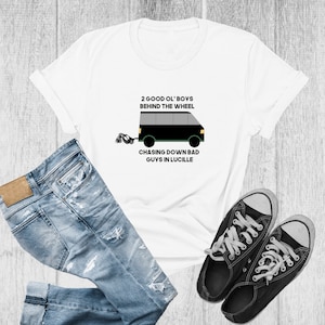 May include: White t-shirt with a black and green illustration of a van with the text "2 good ol' boys behind the wheel chasing down bad guys in Lucille"