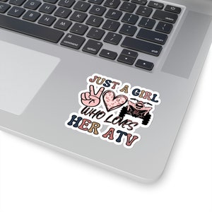 May include: A sticker featuring a peace sign, a heart with a leopard print, and an ATV. The text reads "Just a girl who loves her ATV".