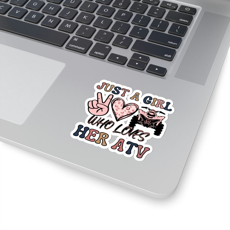 May include: A sticker featuring a peace sign, a heart with a leopard print, and an ATV. The text reads "Just a girl who loves her ATV".