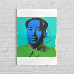 May include: A pop art print depicting a man with blue skin and a green jacket. The background is turquoise, and the print includes the artist's signature and a number.
