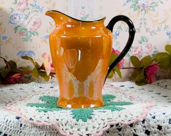 Vintage Czech Phoenix China Iridescent lusterware Creamer or Pitcher with an orange finish and a black handle Art Deco Lustre Ware c 1920-30