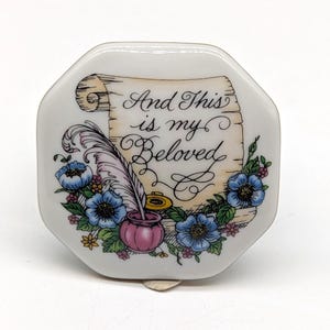 May include: White porcelain octagonal trinket box with a floral design and a scroll with the text "And This is my Beloved".