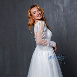 Elegant Tulle Wedding Gown: Laced Bodice, Long Puffy Sleeves