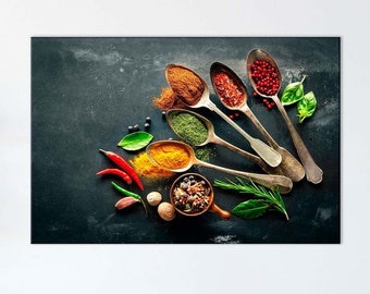 May include: A kitchen scene featuring a canvas print with a close-up of various spices in antique spoons. The spices include red pepper flakes, turmeric, and herbs. Red chili peppers and sprigs of rosemary are also visible.