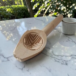 May include: A set of three ceramic mugs with a speckled, matte finish. The mugs are in shades of cream, light brown, and dark brown. Each mug has a simple, minimalist design, perfect for coffee or tea.