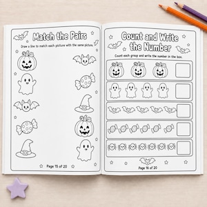 May include: An open activity book featuring black and white Halloween-themed worksheets. The left page shows a Match the Pairs exercise with pumpkins, ghosts, bats, candy, and hats. The right page displays a Count and Write the Number activity.