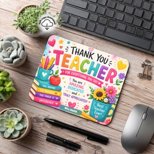 May include: A rectangular mouse pad featuring a colorful design with the text Thank You Teacher for everything you do. It includes illustrations of stacked books, a pencil cup, flowers, and hearts, with the personalized name Mrs Smith printed.