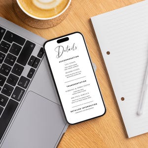 May include: A smartphone displaying wedding details, including accommodation, transportation, and detailed information. The phone is on a wooden surface next to a laptop, a notepad, and a cup of coffee.