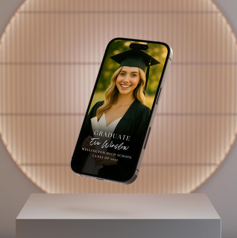 May include: A black smartphone displaying a graduation announcement for Eve Winslow, a graduate of Wellington High School, Class of 2023. The announcement features a photo of Eve in a graduation cap and gown.