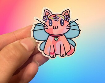 May include: A pink cat with blue wings and a purple flower crown. The cat is wearing a pink collar with a heart charm.