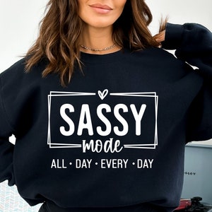 May include: Black sweatshirt with white text that reads "SASSY mode ALL DAY EVERY DAY" with a heart above the word "SASSY".